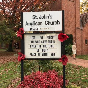 St John's information board with poppies